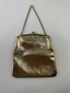 "She fancy - THE DETAILS: Polished shiny metallic gold in color, chain handle, clasp closure, lined ~ Era: 60's ~ Material: man made leather - could be genuine leather but doesn't have tag stating it ~ Condition: Good  - no major flaws, stains on inside, outside is great (see photo) MEASUREMENTS (Flat Lay): ~ Height  8 3/4\" (excludes strap length) ~ Width 9\" ~ Depth 1\"  - Ships quickly - Message with questions - Shop with confidence - No surprises here -  Perfectly imperfect vintage charm may Evening Shoulder Bag With Metal Chain Strap, Chic Metal Shoulder Bag For Formal Occasions, Chic Formal Metal Shoulder Bag, Vintage Gold Shoulder Bag With Gold-tone Hardware, Chic Metal Evening Bag With Chain Strap, Metal Clutch With Chain Strap, Metal Shoulder Bag For Evening, Metallic Metal Evening Bag, Metallic Metal Evening Bags