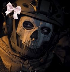 a skull wearing a helmet with a white bow on it