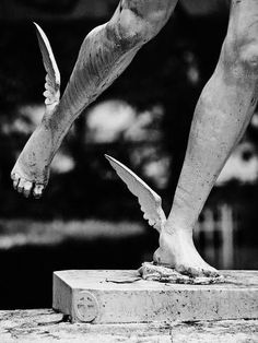 a black and white photo of a person's legs with their feet spread out