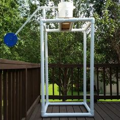 an outdoor toilet on a deck with trees in the background