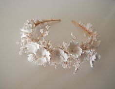 The Freya crown is a floral beauty featuring white clay flowers and glass beads on a fine gold band. A soft, whimsical piece to elevate your bridal look. All pieces are designed and handmade in England, using high quality beads and embellishments, tarnish free jewellery wire and a comfortable headband base ideal for wearing over long periods of time.  LEAD TIME Made to order in 3-4 weeks, plus delivery time.  UK Delivery: 2-5 working days (Royal Mail Tracked) International Delivery: 5-10 working days (International Tracked & Signed) RUSHED ORDERS Please get in touch if you need your piece sooner. This is sometimes possible with a rushed order fee but entirely depends on the design and time frame it is needed within.  CUSTOM DESIGNS Designs can be customised to suit your hairstyle or weddin Bridal Floral Crown, Black Hair Bows, Jewellery Wire, Comfortable Headbands, Occasion Dresses Wedding, Clay Flower, Velvet Hair, Hair Jewelry Wedding, Bridal Look