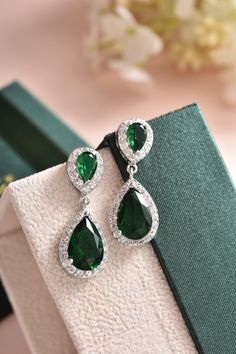 "These green bridal earrings are stunning for bridal occasions whether you want a vintage or classic look. They are made with high quality AAA+ cubic zirconia that glistens on the ear. They come in a sparkling silver finish to give an elegant look. These gorgeous earrings will be carefully wrapped and arrive in a logo gift box. Visit my shop for care instructions and more bridal accessories ➔ https://www.etsy.com/shop/BlushandIvoryStudio Measurements: ► Length: 1.5\" or 3.8 cm ► Width: 0.5\" or Emerald Earrings Real, Green Pear-shaped Earrings For Formal Events, Green Teardrop Diamond Earrings For Anniversary, Elegant Green Dangle Diamond Earrings, Elegant Green Diamond Dangle Earrings, Green Drop Diamond Earrings For Wedding, Classic Green Diamond Drop Earrings, Elegant Green Diamond Drop Earrings, Green Diamond Drop Earrings For Party