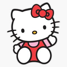 a hello kitty sticker sitting on top of a white surface with a red bow