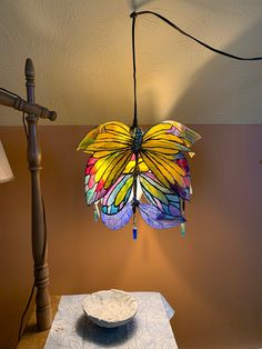 a lamp that is on top of a table next to a plate and lampshade