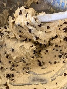 a metal bowl filled with batter and chocolate chips