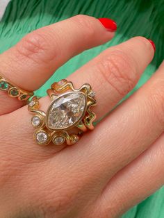 a woman's hand with a ring on it and a diamond in the middle