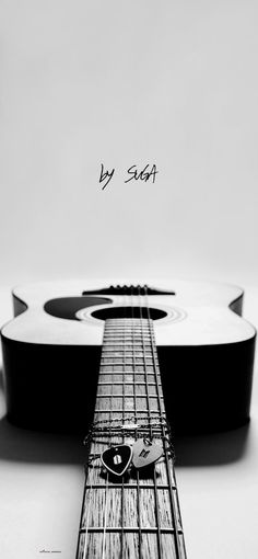 a black and white photo of an acoustic guitar