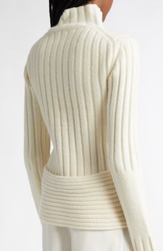 A curved back hem enhances the sculptural shape of this ribbed turtleneck sweater knit from a woolly, cashmere-enriched blend that offers exceptional warmth and comfort. 24" length (size Extra Small) Turtleneck Long sleeves 52% merino wool, 31% nylon, 11% cashmere, 6% spandex Dry clean or hand wash, dry flat Imported Designer Clothing Fitted Ribbed Turtleneck Cardigan, Fitted Ribbed Cashmere Cardigan, Fitted Textured Knit Turtleneck With Funnel Neck, Fitted Turtleneck Cardigan With Textured Knit, Fitted Merino Wool Cardigan With Ribbed Collar, Fitted Turtleneck Cardigan With Ribbed Collar, Elegant Fitted Textured Knit Turtleneck, Elegant Fitted Turtleneck With Ribbed Neckline, Fitted Merino Wool Sweater With Ribbed Neckline