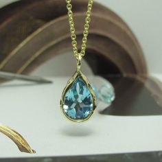 The Necklace And The Pendant Made From 14 Karats Solid Yellow Gold. Chain Length 17.7inch/ 45cm'. Aquamarine Stone House: 0.5x0.6inch/ 12x15mm'. Necklace For Women. Necklace For Men. Special Gold Necklace Bezel Set With A Pear-Shaped Blue Aquamarine. Hand-Made One Of A Kind. This Necklace Is So Simple, Delicate, And Timeless, A Gift That Each Woman Likes To Have. Chain Available In All Sizes, Color Gold And Karat, And Matte Or Shining Finish. Each Pendant Is Custom-Made, Unique, And Will Have Sl Yellow Gold Briolette Sapphire Necklaces, Blue 14k Gold Necklaces For Anniversary, Blue 14k Gold Necklace For Anniversary, Gold Teardrop Sapphire Necklace, Yellow Gold Teardrop Blue Topaz Jewelry, Blue Topaz Drop Necklaces, Blue Drop Necklaces With Blue Topaz, Blue Briolette Necklace For Anniversary, Gold Necklaces With Briolette Sapphire