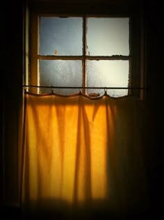 the shadow of a curtain on a window sill