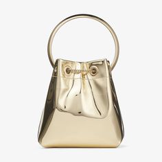 Go for gold with our iconic BON BON Mini handbag. Crafted from shining gold mirror fabric, our signature style features a chain drawstring fastening with tassels and is finished with a metal bracelet top handle. Carry in hand or wear cross-body using the chain strap. Mirror Fabric, Jimmy Choo Handbags, Going For Gold, Backpack Travel Bag, Bon Bon, Mini Handbags, Mini Wallet, Color Dorado, Wallet Bag