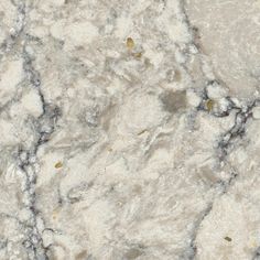 a close up view of a marble surface with gold and white speckles on it