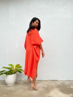 Embrace the gentle waves and sunny shores with our orange double gauze cotton kaftan. This versatile midi-length kaftan falls gracefully between the knees and ankles, making it the perfect beach dress or cover up. Crafted from light and airy double gauze cotton, it's your essential for a night on the town, a day by the sea, or just running errands. Orange Maxi Length Kaftan For Spring, Orange V-neck Midi Dress For Beach, Orange Cotton Midi Dress For Vacation, Orange Spring Kaftan With Kimono Sleeves, Orange Kaftan With Kimono Sleeves For Spring, Orange Cotton Midi Dress For Beach, Orange Kaftan For Spring Beach Cover-up, Summer Midi Dress With Kimono Sleeves, Summer Midi Dress With Kimono Sleeves For Daywear