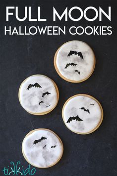 three decorated cookies with bats on them and the words full moon halloween cookies written below