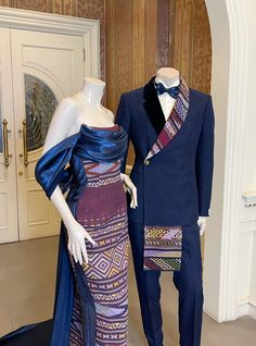 two mannequins dressed up in formal wear, one wearing a blue suit