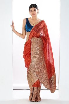 Red, metallic rust pre-draped metallic colorblock saree with stripe woven motifs and textured pattern. Paired with velvet padded blouse and belt.
Components: 3
Type Of Work: Textured
Neckline: Blunt V neck
Sleeve Type: Sleeveless
Fabric: Saree: Metallic Striped Tissue, Blouse: Velvet, Lining: Artificial Crepe
Color: Red,Orange
Other Details: 
Length: 
Saree: 42 inches
Blouse: 14 inches
Approx. product weight: 2 kgs
Note: Only the product mentioned in the description is being sold
Occasion: Desti Bollywood Style Raw Silk Pre-draped Saree For Party, Bollywood Style Pre-draped Raw Silk Saree For Party, Festive Raw Silk Pre-draped Saree For Party, Bollywood Style Party Pre-draped Saree In Raw Silk, Bollywood Style Party Pre-draped Raw Silk Saree, Festive Pre-draped Raw Silk Saree For Party, Party Wear Pre-draped Raw Silk Saree With Pallu, Orange Pre-draped Saree With Unstitched Blouse For Party, Party Pre-draped Raw Silk Saree With Pallu