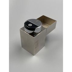 a silver box with a black lid on it