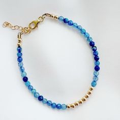 Faceted blue agate + high quality 14k gold filled beads & findings; adjustable. One beaded bracelet Size: 6” + 1.5” gold filled extender Genuine 4mm blue agate 3mm 14k gold filled beads Lobster clasp Does not turn, tarnish, or rust Each natural gemstone is unique and therefore no two are alike. Stones, colors and sizes may vary. Handmade with the highest standards & quality materials. Includes 100% organic cotton jewelry pouch This item is made to order and shipped with love from our studio loca Adjustable Hand-strung 14k Gold Filled Bracelet, Adjustable Spiritual 14k Gold Filled Beaded Bracelet, Spiritual Adjustable 14k Gold Filled Beaded Bracelet, Adjustable 14k Gold-filled Bracelets With Faceted Beads, Adjustable 14k Gold-filled Faceted Beaded Bracelets, Blue Beaded 14k Gold-filled Jewelry, Everyday Blue 14k Gold Filled Bracelets, Adjustable Gold Agate Beaded Bracelets, Blue Beaded Bracelets With Extender