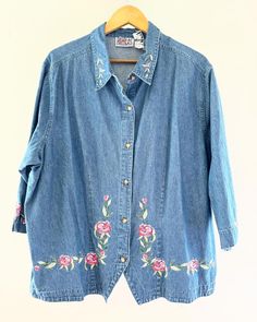 Vintage Bill Blass Women's Jeans Denim Floral Embroidered Denim Button Up Shirt. Boho Country Shirt. Cotton. 3/4 sleeves. Flowers are pinks and greens. No size tag. I would guess it's a 1X or larger. L: 28" underarm to underarm: 27" Check out the rest of our shop: https://instagram.com/hollyshopvintage?igshid=OGQ5ZDc2ODk2ZA== https://hollyshopvintage.etsy.com/ Orders over $35 ship for free. Please check out my Instagram for my newest finds: Hollyshopvintage  Everything priced over $35 has shipping already included in the total price. I'll gladly combine shipping on multiple items to save you money, when it is safe to do so! Message me to make adjustments ahead of time, or make your purchase and I'll refund the shipping overages.  Most items are Vintage. Expect some vintage wear. Items may Spring Medium Wash Shirt With Buttons, Spring Denim Shirt With Snap Buttons, Medium Wash Shirt With Buttons For Spring, Casual Embroidered Button-up Denim Top, Medium Wash Floral Embroidery Button-up Top, Denim Blue Button-up Top With Floral Embroidery, Embroidered Button-up Denim Blue Top, Denim Floral Embroidery Button-up Tops, Embroidered Denim Button-up Shirt