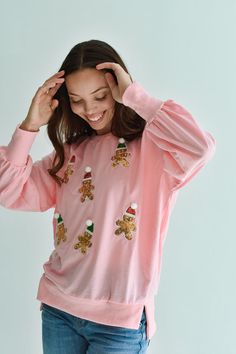 Deck the halls with this festive holiday Sequin Gingerbread Man Shirt. Adorned with colorful sequin gingerbread men, this classic pink pullover shirt is perfect for those cozy winter days and nights. Pair with jeans for daytime or a sequin skirt for a holiday gift exchange. FIT: Fits true to size. We recommend taking your normal size. MATERIAL: 95% Cotton, 5% Polyester. SIZE GUIDE: S (2-4) / M (6-8) / L (10-12) MODEL DETAILS: Our model Karlie (photos) is 5'7 and wearing a size S. Karlie's measur Holiday Gift Exchange, Rehearsal Dinner Dresses, Man Shirt, Pink Pullover, Gingerbread Men, Men Sweatshirt, Dinner Dress, Gift Exchange, Winter Days