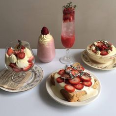 three desserts on plates with strawberries and icecream next to each other