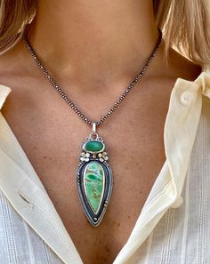 This handmade boho necklace features a stunning green stone pendant crafted from variscite and chrysoprase, set in sterling silver with a nature-inspired design. The customizable chain allows for versatile styling, making this variscite and chrysoprase gemstone jewelry piece a perfect gift for those who appreciate unique, handcrafted accessories.  A Wearable Work of Art ✓ Meticulously handcrafted by skilled metalsmiths using sterling silver, variscite, and chrysoprase ✓ gemstones ✓ Boho-chic design with intricate floral and beaded details, perfect for nature lovers and bohemian fashion enthusiasts ✓ Versatile piece suitable for both everyday wear and special occasions ✓ Customizable chain length (17-21 inches) at no additional cost for the perfect fit ✓ Unique statement piece that makes an Bohemian Turquoise Pendant Necklace With Oxidized Finish, Green Oxidized Artisan Jewelry, Green Artisan Jewelry With Oxidized Finish, Artisan Green Jewelry With Oxidized Finish, Artisan Green Jewelry For Festival, Bohemian Jewelry With Oval Pendant Natural Stones, Bohemian Green Gemstone Jewelry, Bohemian Teardrop Oxidized Jewelry, Bohemian Oxidized Teardrop Necklaces