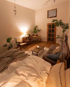 a bed room with a neatly made bed next to a table and chair in it