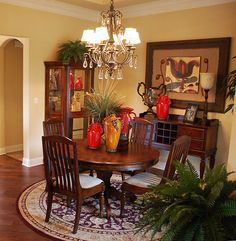 a dinning room table with chairs and vases on it