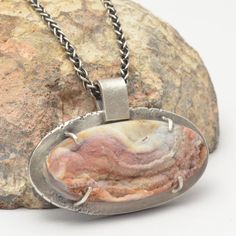 "This sterling silver pendant necklace features an oval concho druzy in shades of white, brown and muted pink. The stone is so beautiful that I left a window on the back so you can see the back of the stone, which reveals the black and gray lace agate under the druzy. The stone has been set in a pendant of sterling silver with an organic, textured edge. The necklace has been oxidized and selectively brushed to highlight the details. This necklace is stamped with my maker's mark. The pendant is a Untreated Agate Pendant Jewelry, Unique Oval Pendant Jewelry With Large Stone, Sterling Silver Jewelry With Large Oval Stone Pendant, Sterling Silver Necklace With Large Oval Stone, Oval Sterling Silver Necklace With Large Stone, Oval Agate Necklace With Large Pendant, Silver Necklace With Large Oval Cabochon Stone, Collectible Oval Necklace With Large Stone, Artisan Oval Necklace With Large Stone