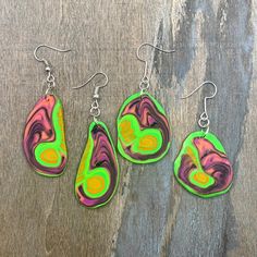 Lightweight neon green, pink, orange and black earrings that glow in UV light - perfect for dancing at a rave or party! This is a one-off design, so these are truly unique earrings! Earring hooks are made from stainless steel.  All packaging is recyclable and/or recycled. Adjustable Funky Earrings For Festivals, Handmade Rave Jewelry For Party, Neon Yellow Drop Earrings As A Gift, Trendy Neon Jewelry For Party, Fun Green Drop Earrings, Green Fun Drop Earrings, Green Artsy Earrings For Party, Artsy Green Earrings For Party, Artsy Green Earrings For Festival