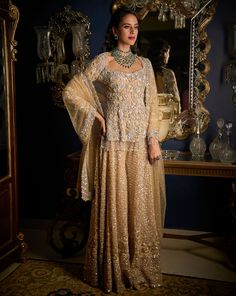 This sharara set features all over sequin and bead embroidery in tones of nude and silver grey. The ensemble shows beaded fringe at the wrist and at the hem of the sharara top. The matching dupatta has delicate cut work on all four sides. DELIVERY TIMEPlease allow 8-12 weeks for your outfit to arrive. FABRIC DETAILSSharara - Net / Dupatta - Net Professional cleaning only. Silver Sharara, Dupatta Jacket, Flared Sharara, Desi Clothes, Embroidered Dupatta, Sequin Jacket, Sharara Set, Net Dupatta, Reception Wedding