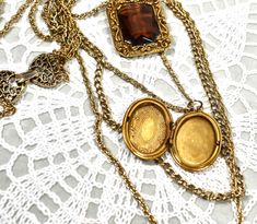 "This is truely a rare find, a 1950 circa neckalce is made by Goldette a company well know for lockets, pendants and intrigent design work. Four varing sized gold tone chains holds a large Goldette pendant with open back Golden faceted crystal set in a gold tone richly ornate rectangle and the locket is ornately etched, antiqued gold tone in \"mint\" condition inside and outside. Stamped GOLDETTE on clasp. Please feel free to compare this necklace with other Goldette's. You will find it to be pr Vintage Jeweled Chain Necklace Gift, Vintage Jeweled Chain Necklace As A Gift, Vintage Jewel Chain Necklace As Gift, Vintage Jewel Chain Necklace For Gift, Vintage Gold-tone Locket Necklaces, Gold Jewelry For Vintage Collection, Vintage Antique Gold Chain Necklace, Vintage Costume Jewelry Necklace With Locket, Vintage Costume Jewelry Locket Necklace