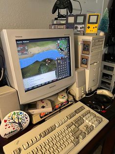 an old computer monitor sitting on top of a desk next to a keyboard and mouse