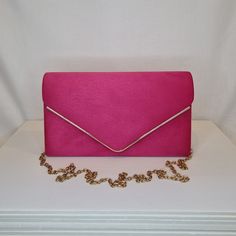 Womens fuschia pink faux suede evening clutch bag with front gold detailing and magnet front closing clasp Can be used with or without long shoulder chain (included) size approx- H 14cm x W 24cm Optional Dust Bag: White lightweight soft polyester portable travel dust bag pouch, suitable for protecting items from dust, dirt, hairs and scratches when not in use size approx- L 47cm x W 31.5cm Material: 100% polyester Please note, there is a cut in the top corner of the bag. In order to reveal the d Formal Pink Bags With Magnetic Closure, Pink Formal Bags With Magnetic Closure, Pink Evening Pouch Shoulder Bag, Feminine Pink Pouch Evening Bag, Pink Clutch With Chain Strap For Formal Occasions, Pink Pouch Evening Bag, Pink Envelope Clutch For Formal Occasions, Pink Envelope Clutch For Evening, Pink Evening Bag With Magnetic Closure