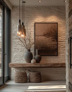 two vases are sitting on a table in the middle of a room with large windows