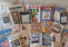 an assortment of cross stitch patterns and books