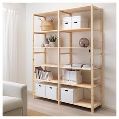 a book shelf with several boxes and baskets on it