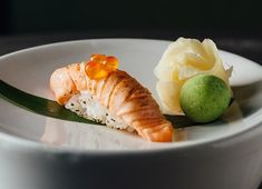 a white bowl filled with food on top of a table