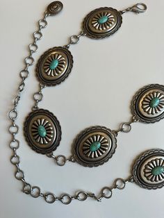 Stunning classic faux turquoise chain belt! The conchos are a lovely quality, with beautiful western style engravings/sculpting thats called a sunburst design Scalloped edging as well. Oval shaped faux turquoise stone. Scalloped oval shaped conchos.  Really nice thick coating of vintage antique old silver plating. Love the tip of the chain belt detail as well, it's a small version of the concho without the turquoise. Total length of chain belt. Clasp to tip 47'' Wearable at 29 inch waist, all the way to a 38 inch waist.  8 conchos. Vintage Concho Jewelry For Ranch, Vintage Turquoise Necklace For Festivals, Western Belt Buckles, Western Belt, Western Belts, Southwest Style, Chain Belt, Western Style, Belt Buckle