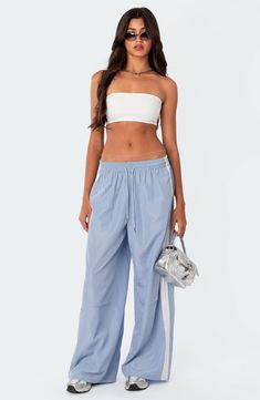 Sporty stripes trail the sides of these wide-leg track pants topped with a comfortable elastic waist. 100% polyester Machine wash, dry flat Imported Nylon Track Pants, Legging Court, Tie Dye Sweatpants, Swimwear Dress, Active Wear Pants, Nylon Fabric, Bandeau Top, Christmas 2024, Side Stripe