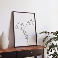 a black and white drawing on a wall next to a table