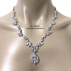 "A piece of woodland wedding nature inspired statement bridal necklace featuring vines, leaves parts and flower pendant, made of sparkly clear cubic zirconia. This beautiful cz jewelry comes in tarnish-resistant silver rhodium plated chain. Necklace length options: - 17\" (43cm) with a snap clasp - 19\" (48cm) including a 2\" chain extender on a spring clasp (as shown on display). View matching pieces or similar designs at https://etsy.me/2eR38KG View designs related to vines, branches, twigs or Glamorous Bridal Necklace With Diamond Accents, Glamorous Cubic Zirconia Bridal Necklace With Diamond Accents, Glamorous Bridal Necklace With Rhinestones, Glamorous Bridal Necklace With Rhinestones And Cubic Zirconia, Vintage Diamond Necklace With Brilliant Cut For Wedding, Glamorous Cubic Zirconia Bridal Necklace With Rhinestones, Glamorous Cubic Zirconia Bridal Necklace For Formal Occasions, Dazzling Cubic Zirconia Rhinestone Necklace For Anniversary, Glamorous Bridal Necklace With Diamond Accents For Wedding