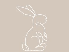 the outline of a rabbit sitting in front of a light brown background with white writing on it