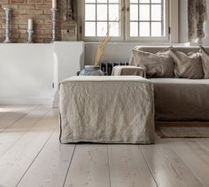 a living room filled with furniture and windows