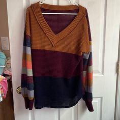 Is A Reposh And Never Used Does Not Contain Size Tags But Is 21 Pit To Pit. Would Fit A Medium Or A Large. V Neck. Wear A Top Or Tank Under. Sleeves Are Multi Colored Sweater Material. I Bundle Items And Can Reduce Shipping Make An Offer. Multicolor Color Block Top For Fall, Winter Color Block V-neck Top, Casual Burgundy Knit Top, Winter V-neck Color Block Tops, Knit Color Block Tops For Fall, Fall Color Block Knit Tops, Fall Knit Color Block Tops, Trendy Brown Color Block Tops, Burgundy Knit Top For Fall