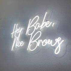 a white neon sign that says hey bake me brown's on the wall