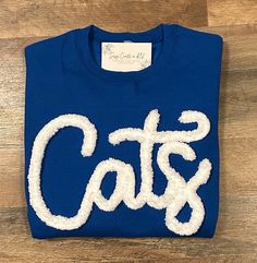 Show your school spirit in this cute sweatshirt. Comfort, casual and loose fitting, made on 50/50 cotton/poly blend shirts.  Embroidered chenille yarn, Cats sweatshirt. Solid white yarn.  Please message us if you have a custom color request and we will create a separate listing for custom requests.  You can follow us at the below link for chances to win giveaways and to see all of our latest creations.  https://www.facebook.com/groups/710060383256657/?ref=share&mibextid=S66gvF