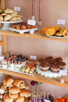 an assortment of baked goods displayed on wooden shelves