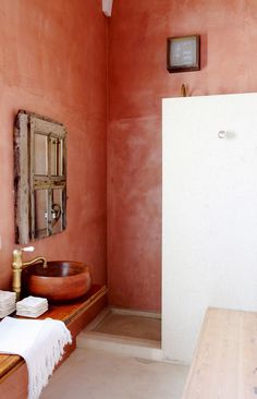 a bathroom with a sink, mirror and wooden counter