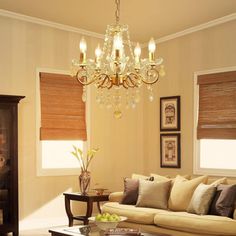 a living room filled with furniture and a chandelier hanging over it's head